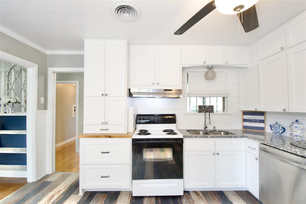 1307 North 65th Street Waco, TX 76710 - Photo 12 of 35 a kitchen with granite countertop white cabinets and appliances