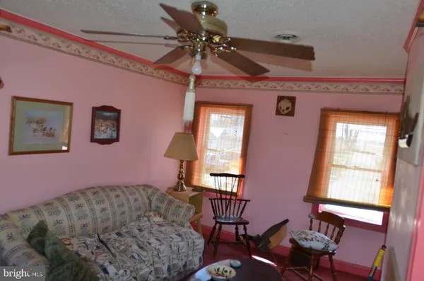 a bedroom with a bed next to a window