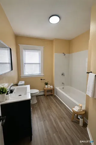 a bathroom with a sink a toilet and a bathtub