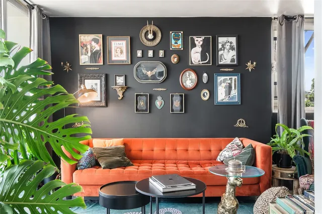 a living room with furniture and a potted plant