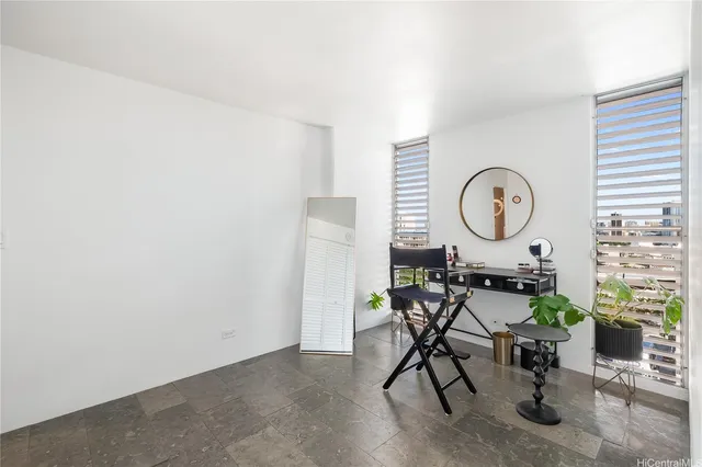 a view of a room with furniture and a mirror