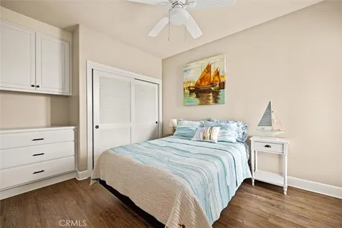 a bedroom with a bed and a painting on the wall