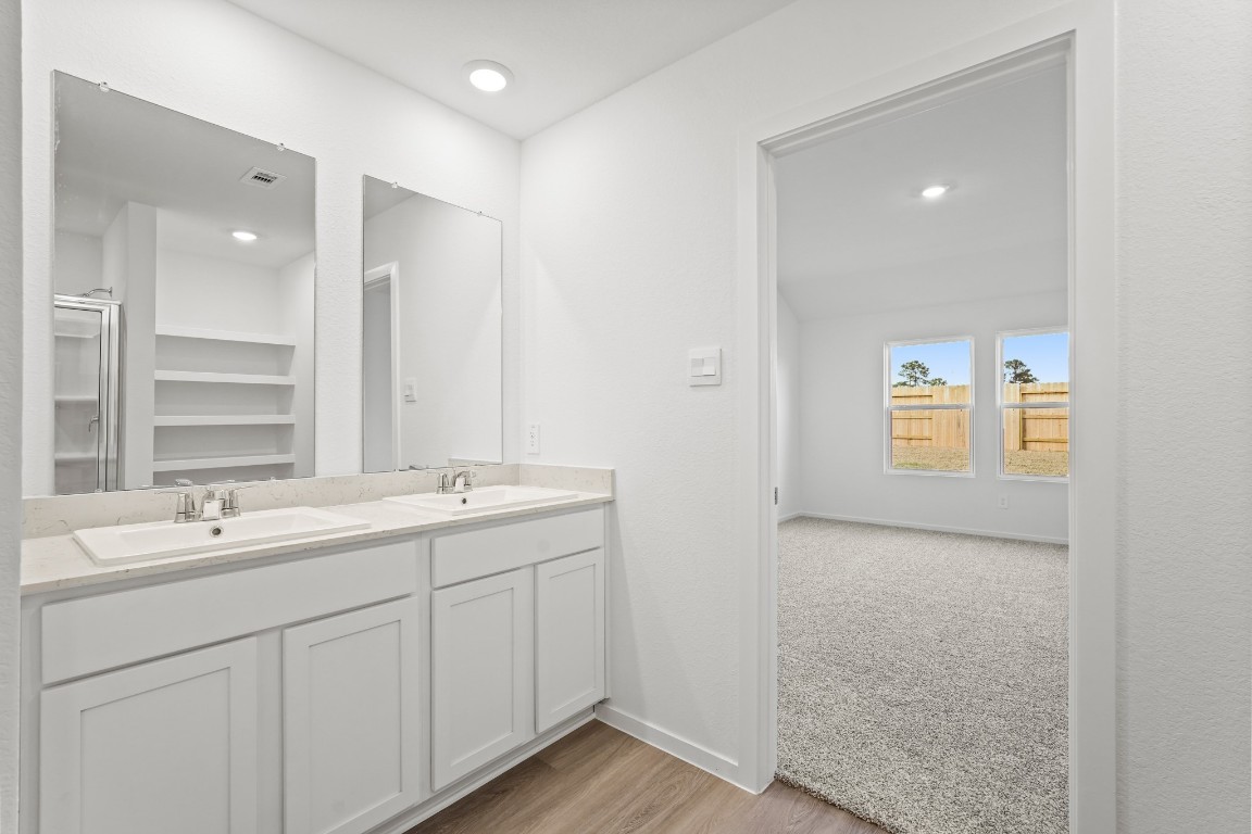 525 Wax Myrtle Way Hockley, TX 77447 - Photo 11 of 20 a bathroom with 2 sink tub and a mirror