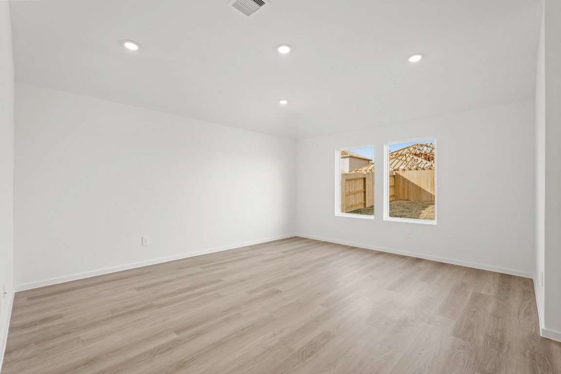 525 Wax Myrtle Way Hockley, TX 77447 - Photo 14 of 20 a view of an empty room with wooden floor and window