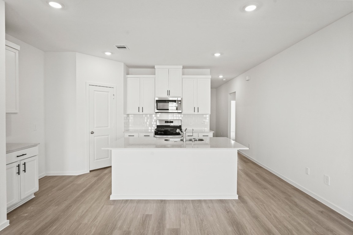 525 Wax Myrtle Way Hockley, TX 77447 - Photo 4 of 20 a view of kitchen with stainless steel appliances cabinets and wooden floor