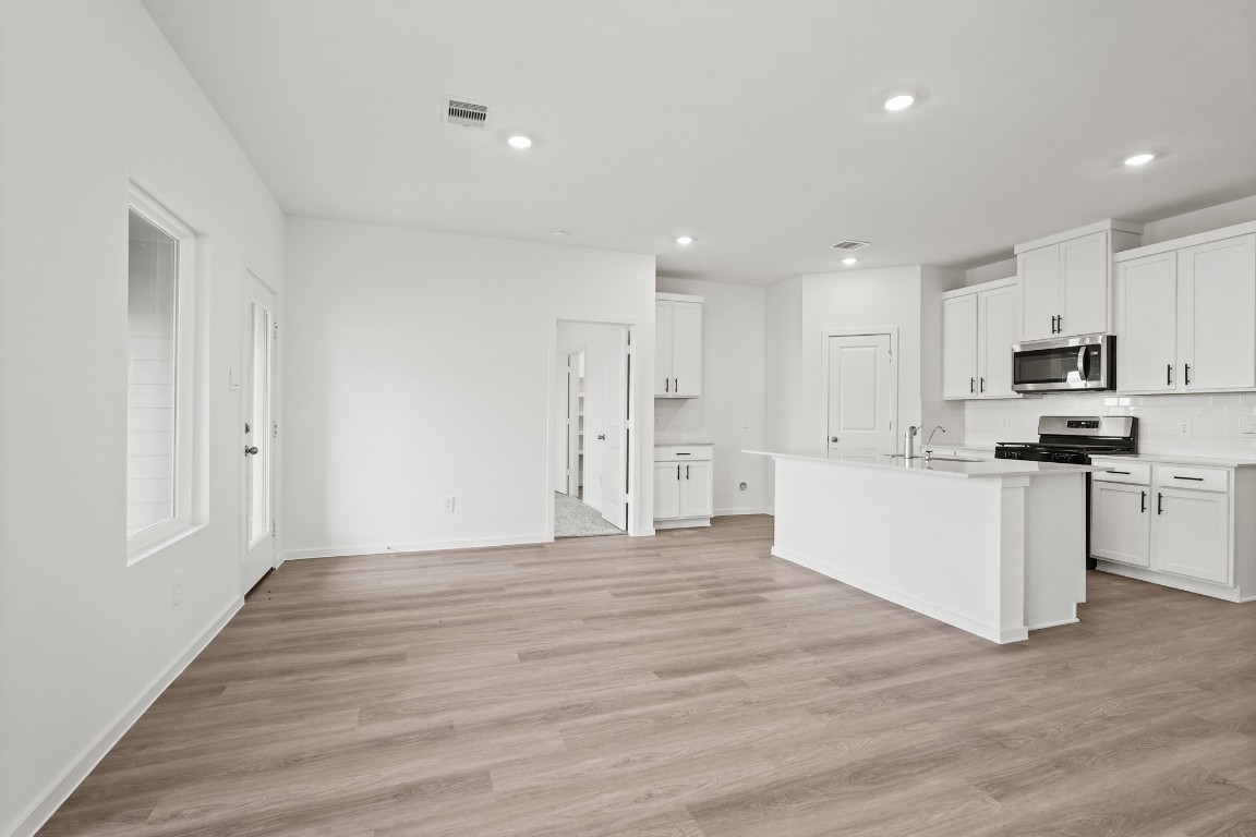 525 Wax Myrtle Way Hockley, TX 77447 - Photo 5 of 20 a view of kitchen with wooden floor and electronic appliances