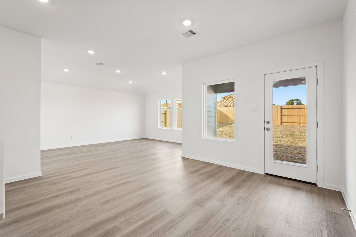 525 Wax Myrtle Way Hockley, TX 77447 - Photo 7 of 20 an empty room with wooden floor and windows