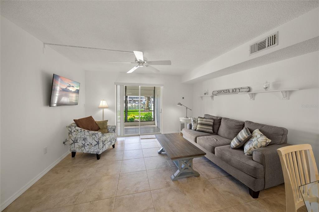 9200 Midnight Pass Road, Unit 17 Sarasota, FL 34242 - Photo 14 of 56 a living room with furniture and a couch