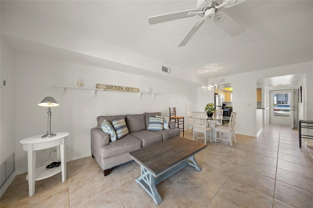 9200 Midnight Pass Road, Unit 17 Sarasota, FL 34242 - Photo 16 of 56 a living room with furniture and a table