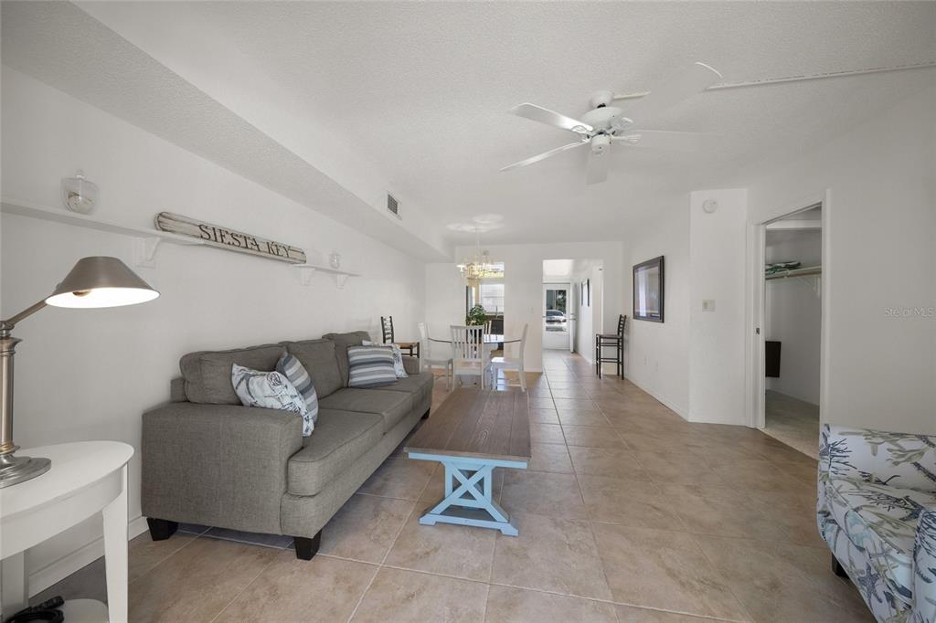 9200 Midnight Pass Road, Unit 17 Sarasota, FL 34242 - Photo 17 of 56 a living room with furniture and a chandelier