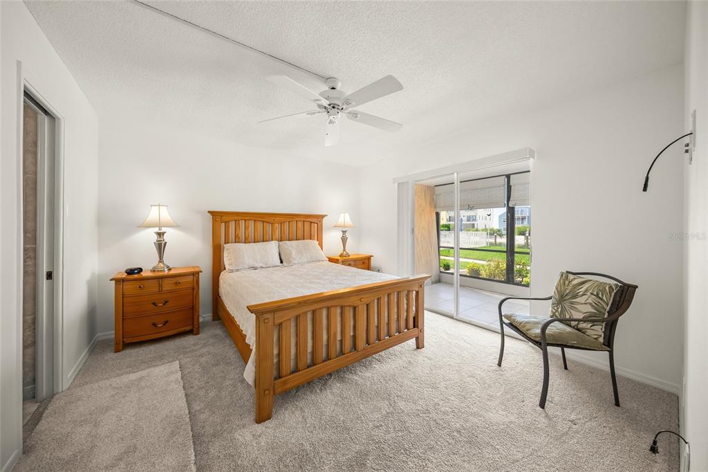 9200 Midnight Pass Road, Unit 17 Sarasota, FL 34242 - Photo 18 of 56 a bedroom with a bed chair and window