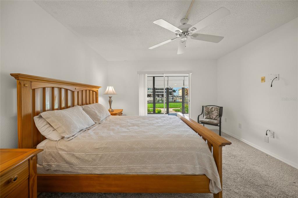 9200 Midnight Pass Road, Unit 17 Sarasota, FL 34242 - Photo 19 of 56 a bed sitting in a bedroom next to a window