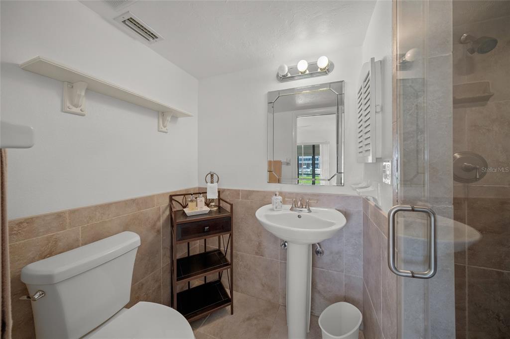 9200 Midnight Pass Road, Unit 17 Sarasota, FL 34242 - Photo 21 of 56 a bathroom with a toilet sink and mirror