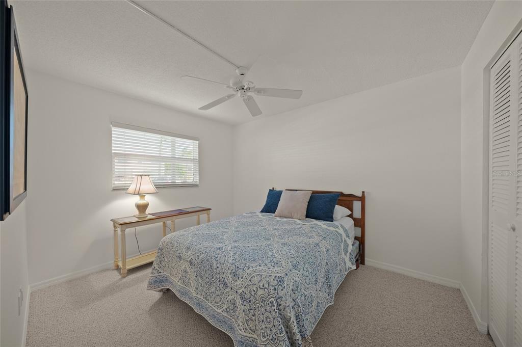 9200 Midnight Pass Road, Unit 17 Sarasota, FL 34242 - Photo 23 of 56 a bedroom with a bed and window