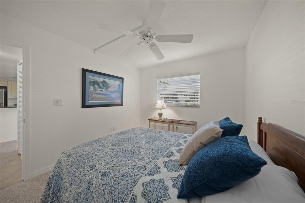 9200 Midnight Pass Road, Unit 17 Sarasota, FL 34242 - Photo 24 of 56 a bedroom with a bed and a window