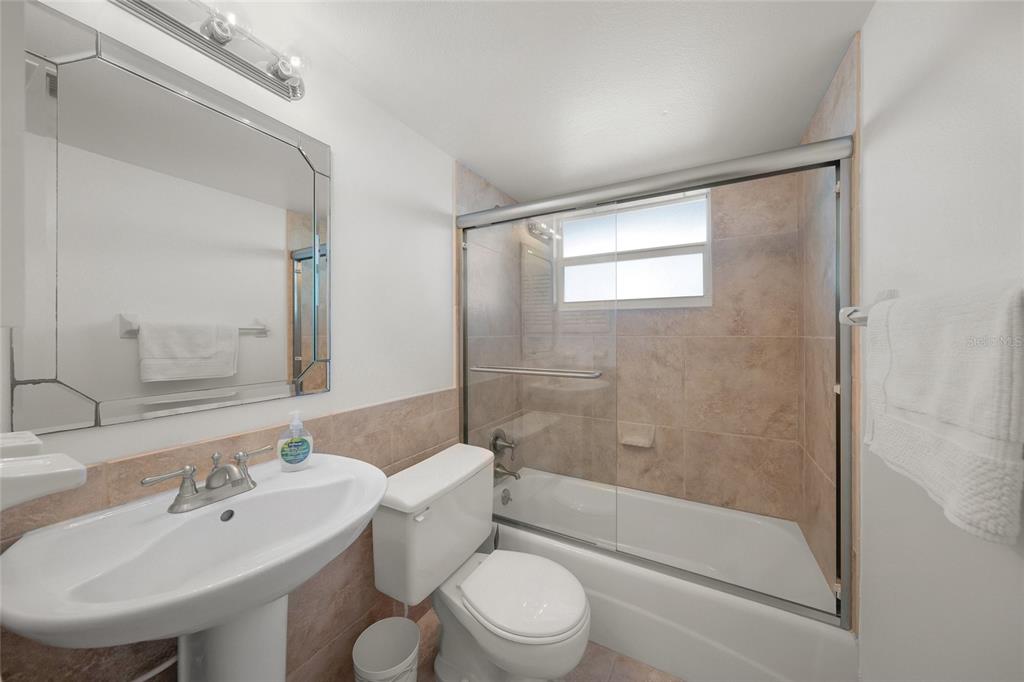 9200 Midnight Pass Road, Unit 17 Sarasota, FL 34242 - Photo 26 of 56 a bathroom with a sink toilet and shower