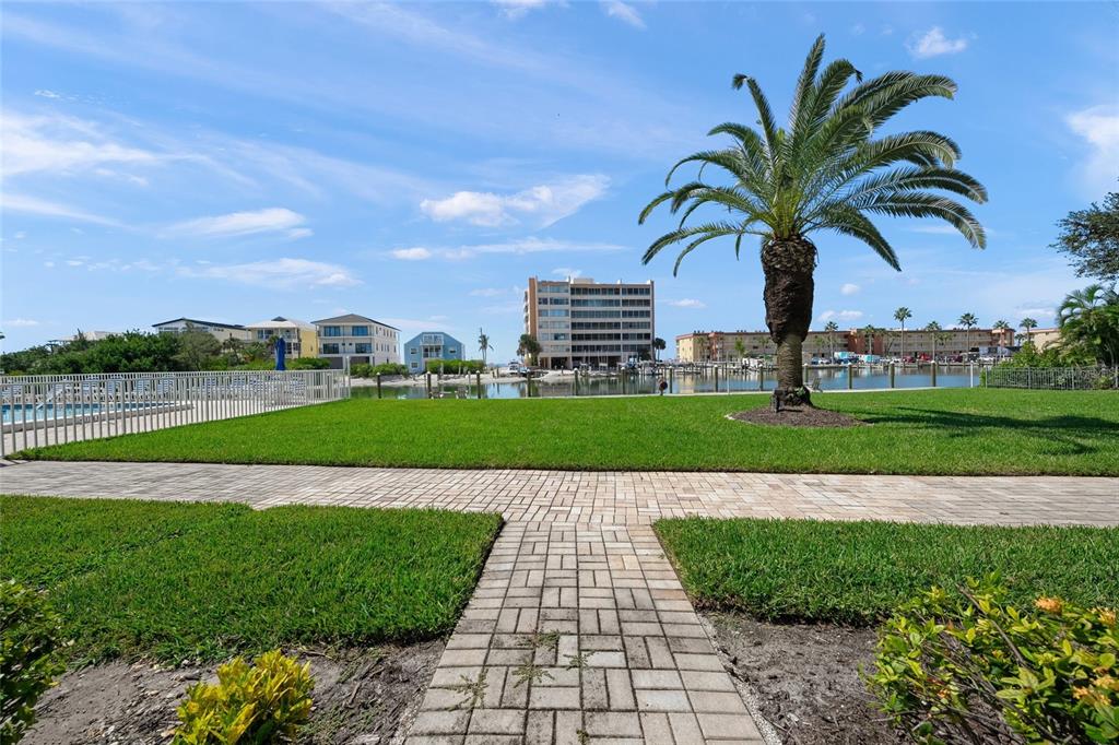 9200 Midnight Pass Road, Unit 17 Sarasota, FL 34242 - Photo 30 of 56 a view of a swimming pool and a yard