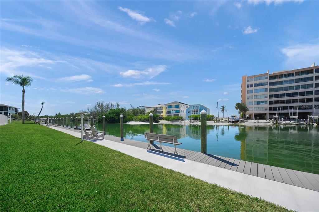 9200 Midnight Pass Road, Unit 17 Sarasota, FL 34242 - Photo 33 of 56 a view of a lake with a city from a bench