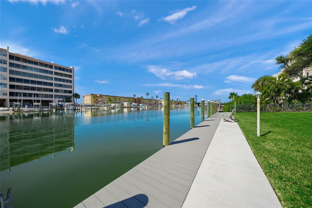 9200 Midnight Pass Road, Unit 17 Sarasota, FL 34242 - Photo 34 of 56 a view of a lake with a yard