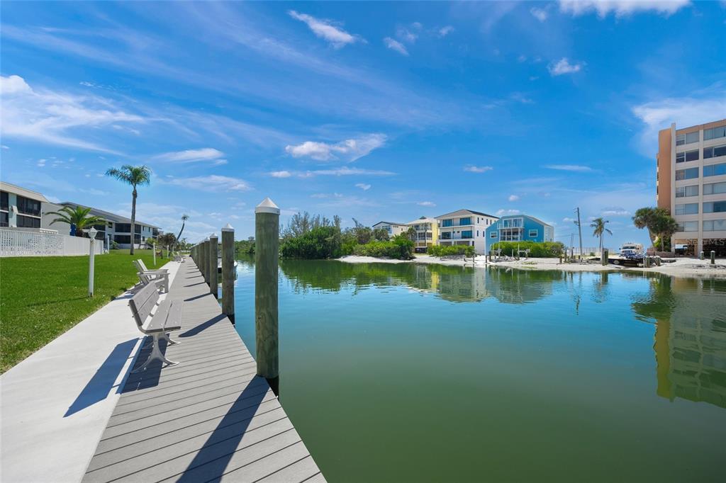 9200 Midnight Pass Road, Unit 17 Sarasota, FL 34242 - Photo 35 of 56 a view of a lake with a garden