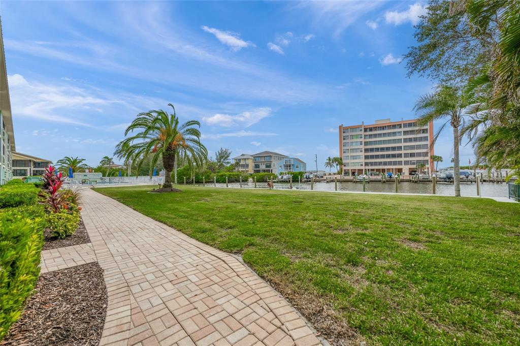 9200 Midnight Pass Road, Unit 17 Sarasota, FL 34242 - Photo 36 of 56 a front view of a house with garden