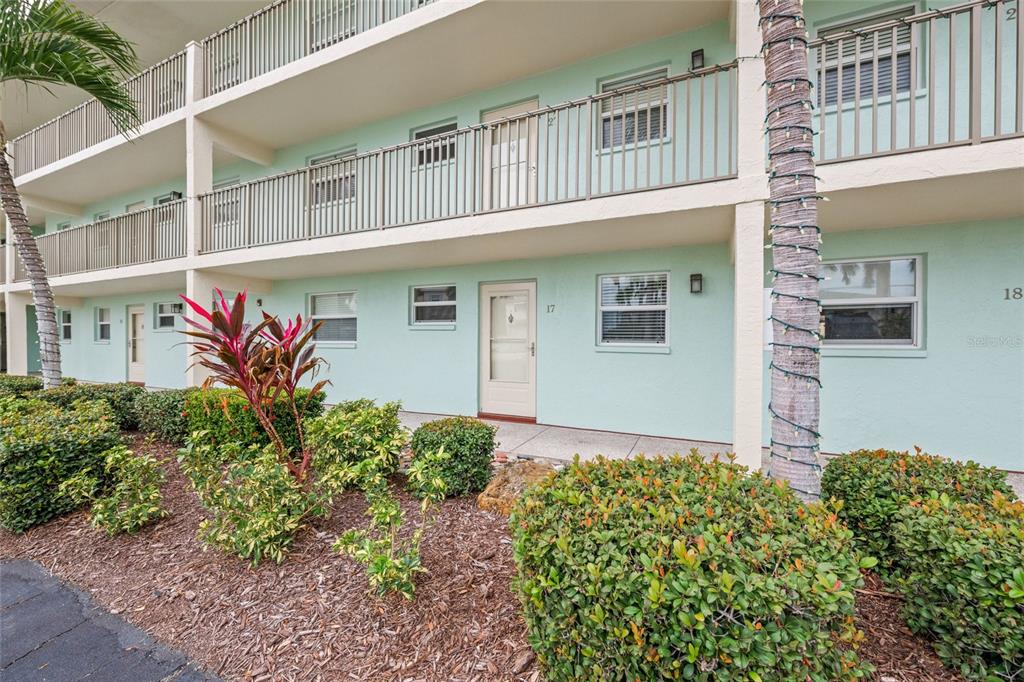 9200 Midnight Pass Road, Unit 17 Sarasota, FL 34242 - Photo 39 of 56 a front view of a house with garden