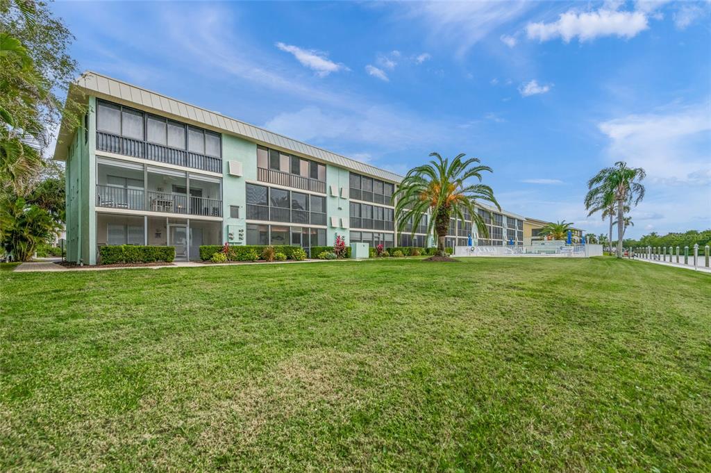 9200 Midnight Pass Road, Unit 17 Sarasota, FL 34242 - Photo 40 of 56 a view of a house with yard and sitting area