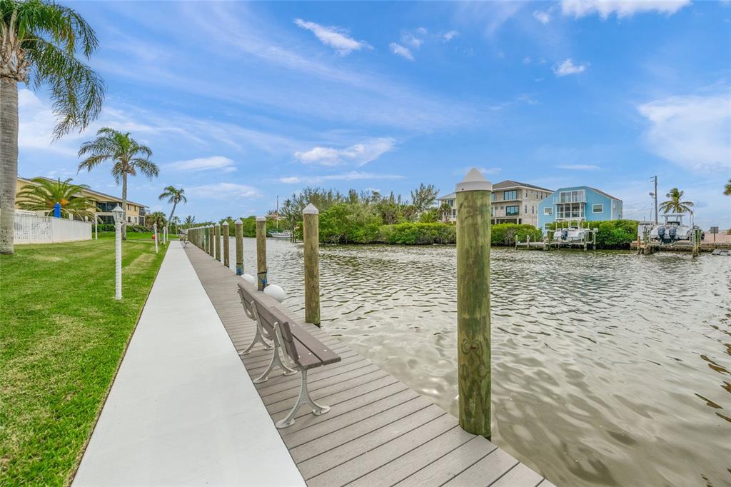9200 Midnight Pass Road, Unit 17 Sarasota, FL 34242 - Photo 42 of 56 a view of a lake with a yard