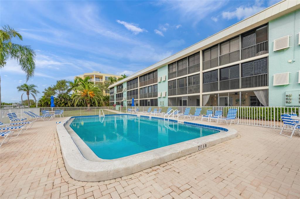 9200 Midnight Pass Road, Unit 17 Sarasota, FL 34242 - Photo 43 of 56 a view of a swimming pool with a patio