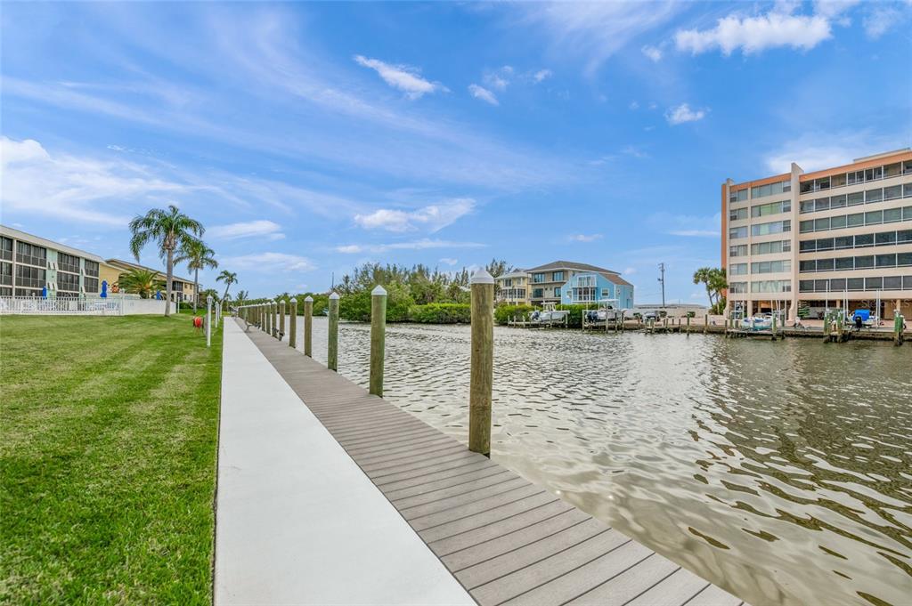 9200 Midnight Pass Road, Unit 17 Sarasota, FL 34242 - Photo 46 of 56 a view of a lake with boats and trees in the background