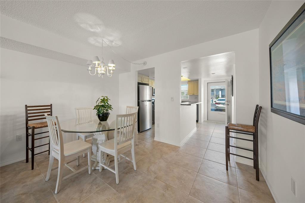 9200 Midnight Pass Road, Unit 17 Sarasota, FL 34242 - Photo 8 of 56 a dining room with furniture and window