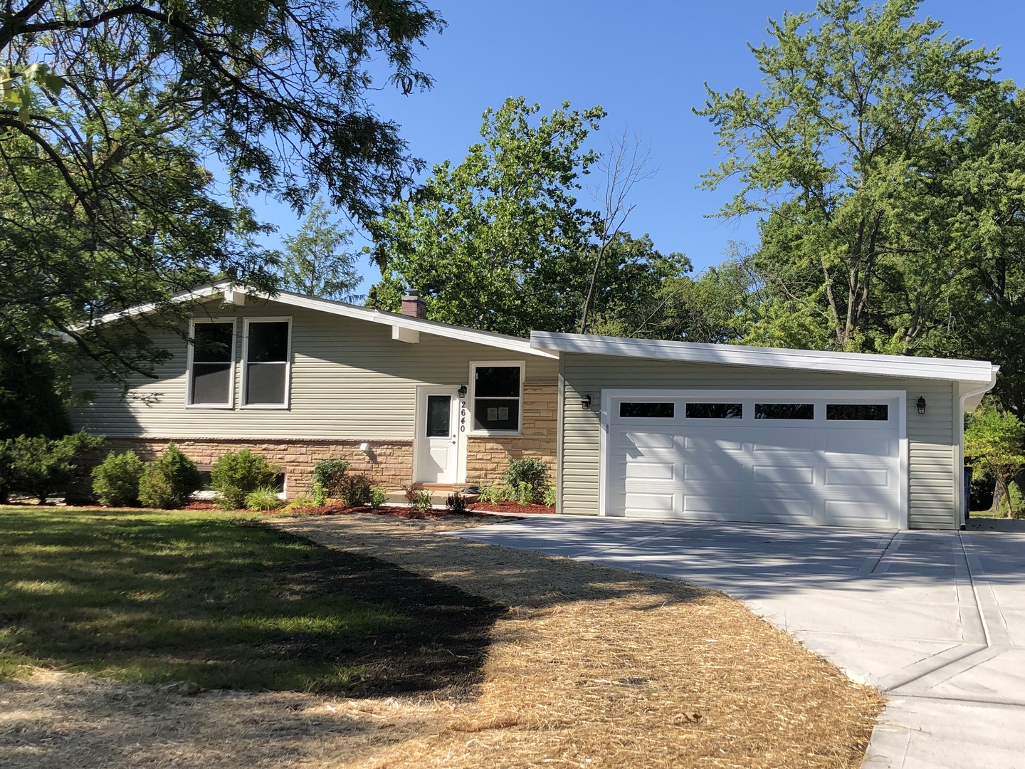 2640 Deerfield Road Riverwoods, IL 60015 - Photo 1 of 15 a front view of a house with garden