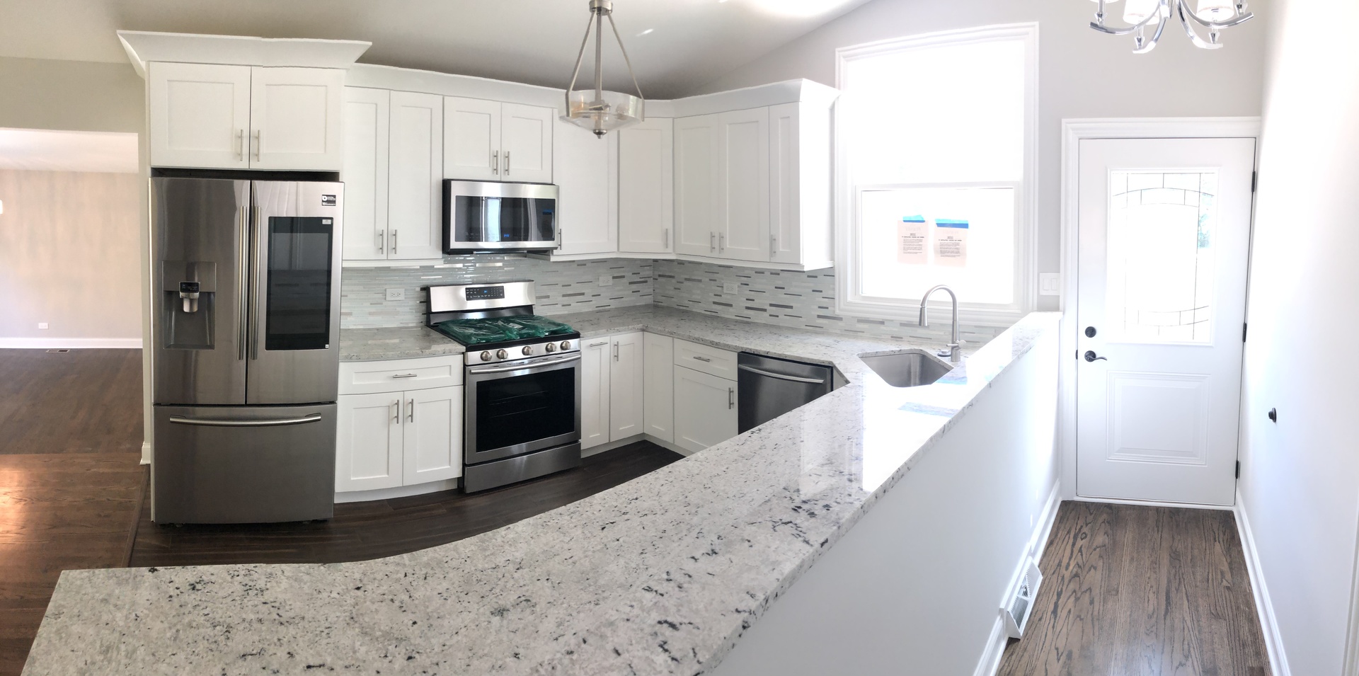 2640 Deerfield Road Riverwoods, IL 60015 - Photo 4 of 15 a kitchen with stainless steel appliances kitchen island granite countertop a refrigerator a stove a sink dishwasher and a oven with wooden floor