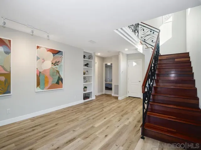 a view of entryway and hall with wooden floor