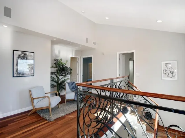 a spacious bedroom with a bed a couch and a potted plant