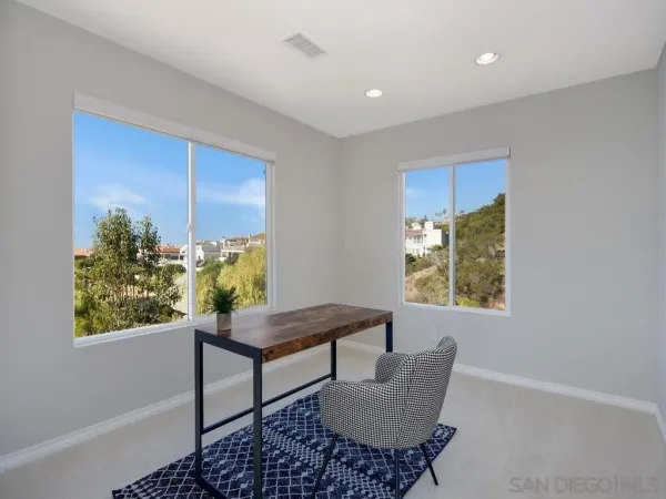 a view of table chair and potted plant