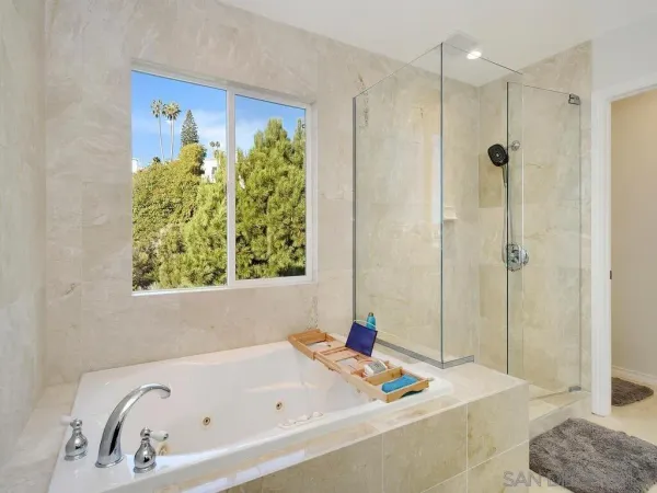 a bathroom with a sink a shower and a mirror