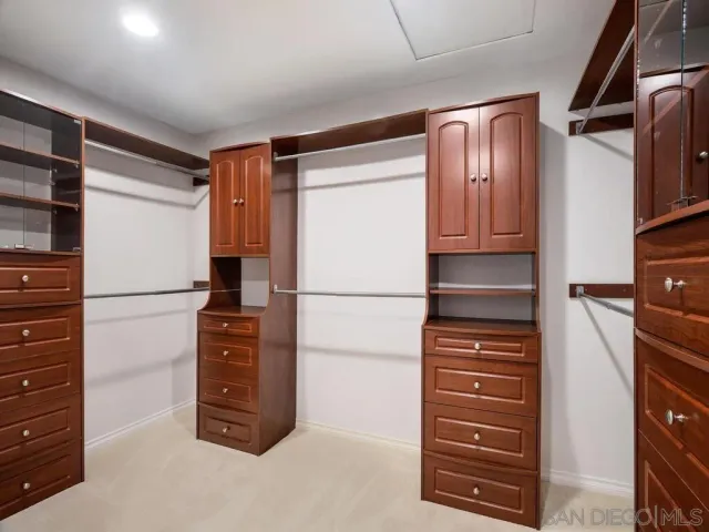 a bedroom with two beds and painting on the wall