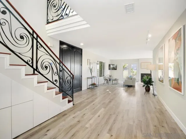 a view of entryway and hall with wooden floor