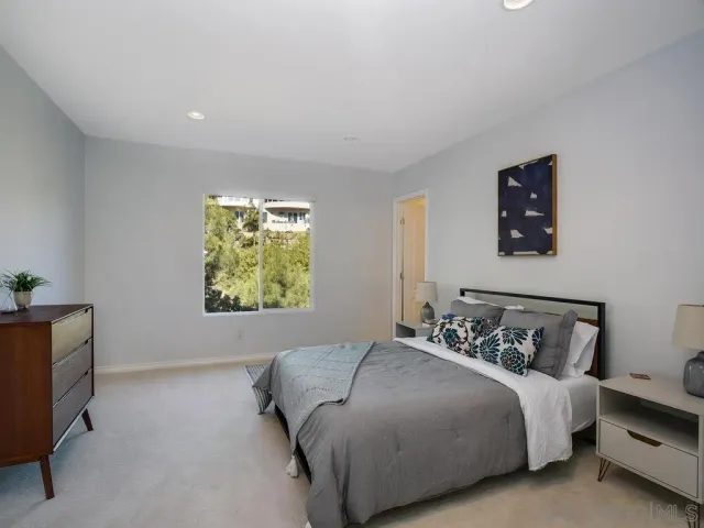 a bathroom with a toilet a sink a glass door a shower and a mirror