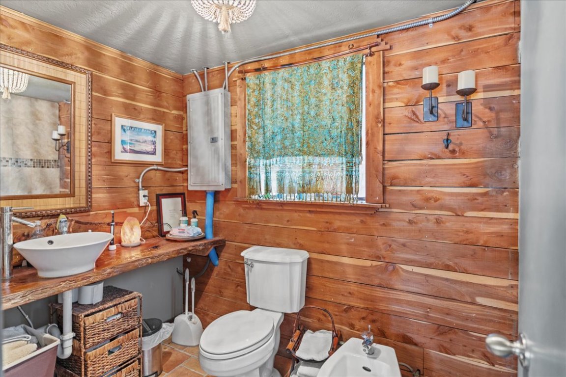 16933 B Ranch Road 12, Unit B Wimberley, TX 78676 - Photo 14 of 19 a bathroom with a sink a toilet and shower curtain
