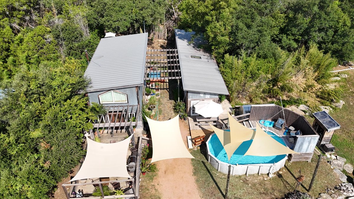 16933 B Ranch Road 12, Unit B Wimberley, TX 78676 - Photo 18 of 19 an aerial view of a house with outdoor space and trees