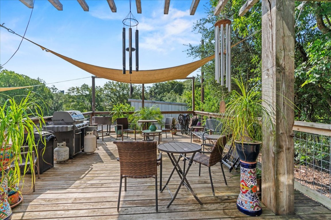 16933 B Ranch Road 12, Unit B Wimberley, TX 78676 - Photo 6 of 19 a view of a dining table and chairs in the patio