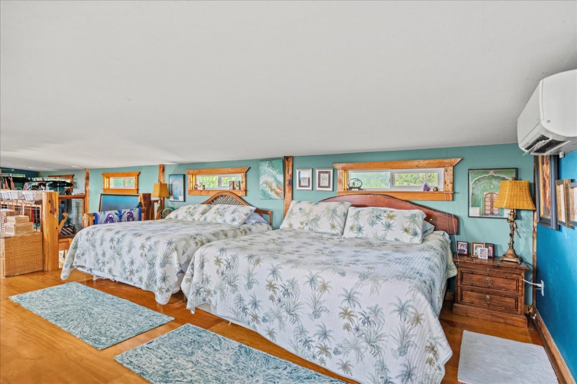 16933 B Ranch Road 12, Unit B Wimberley, TX 78676 - Photo 8 of 19 a bedroom with bed and glass door