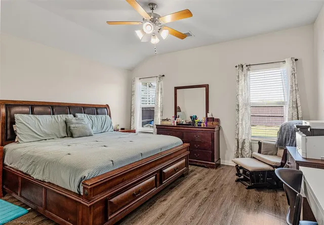 a bedroom with a bed and a chandelier