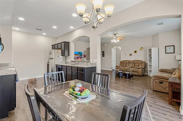 a living room with furniture kitchen view and a dining table