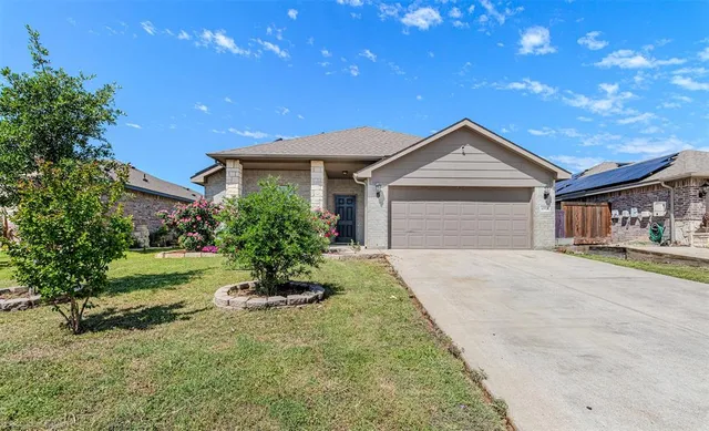 a front view of house with yard and green space