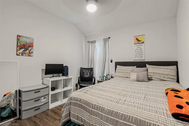 a bedroom with a bed and flat screen tv