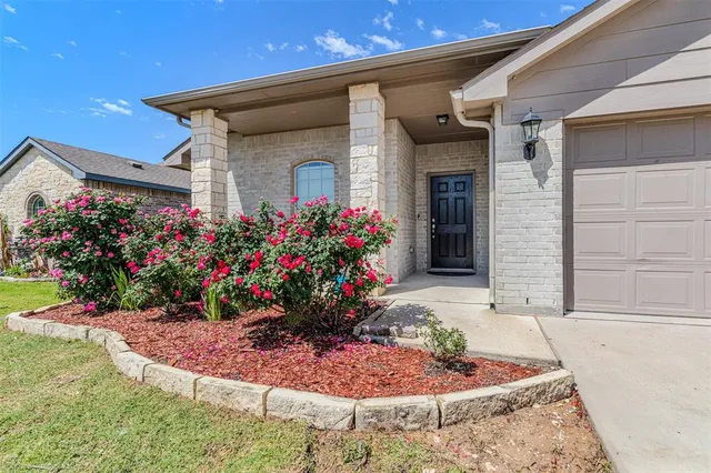 a view of a house with a flower garden