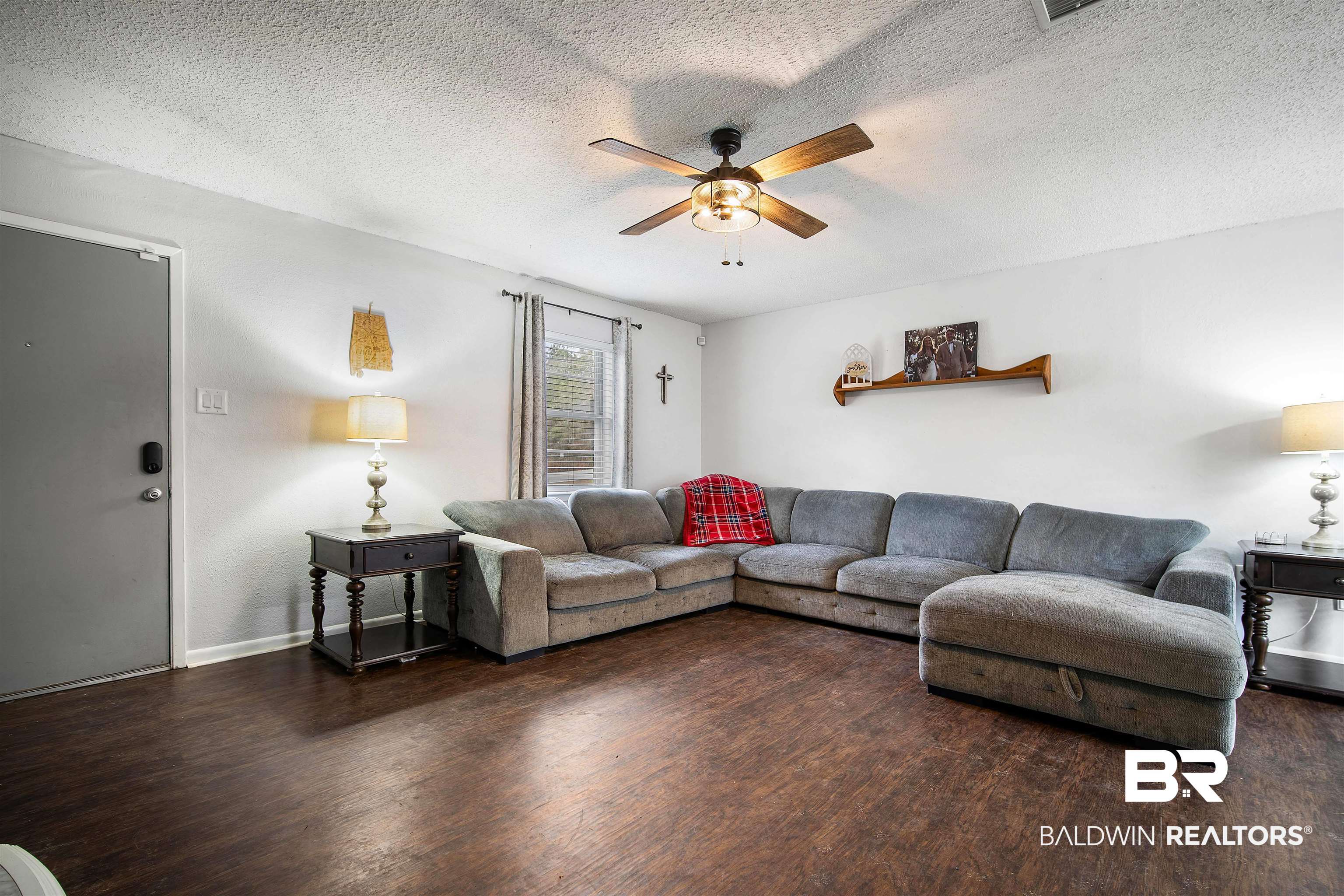 5110 Wilmer Road Wilmer, AL 36587 - Photo 6 of 24 Living room featuring ceiling fan, dark hardwood / wood-style floors, and a textured ceiling